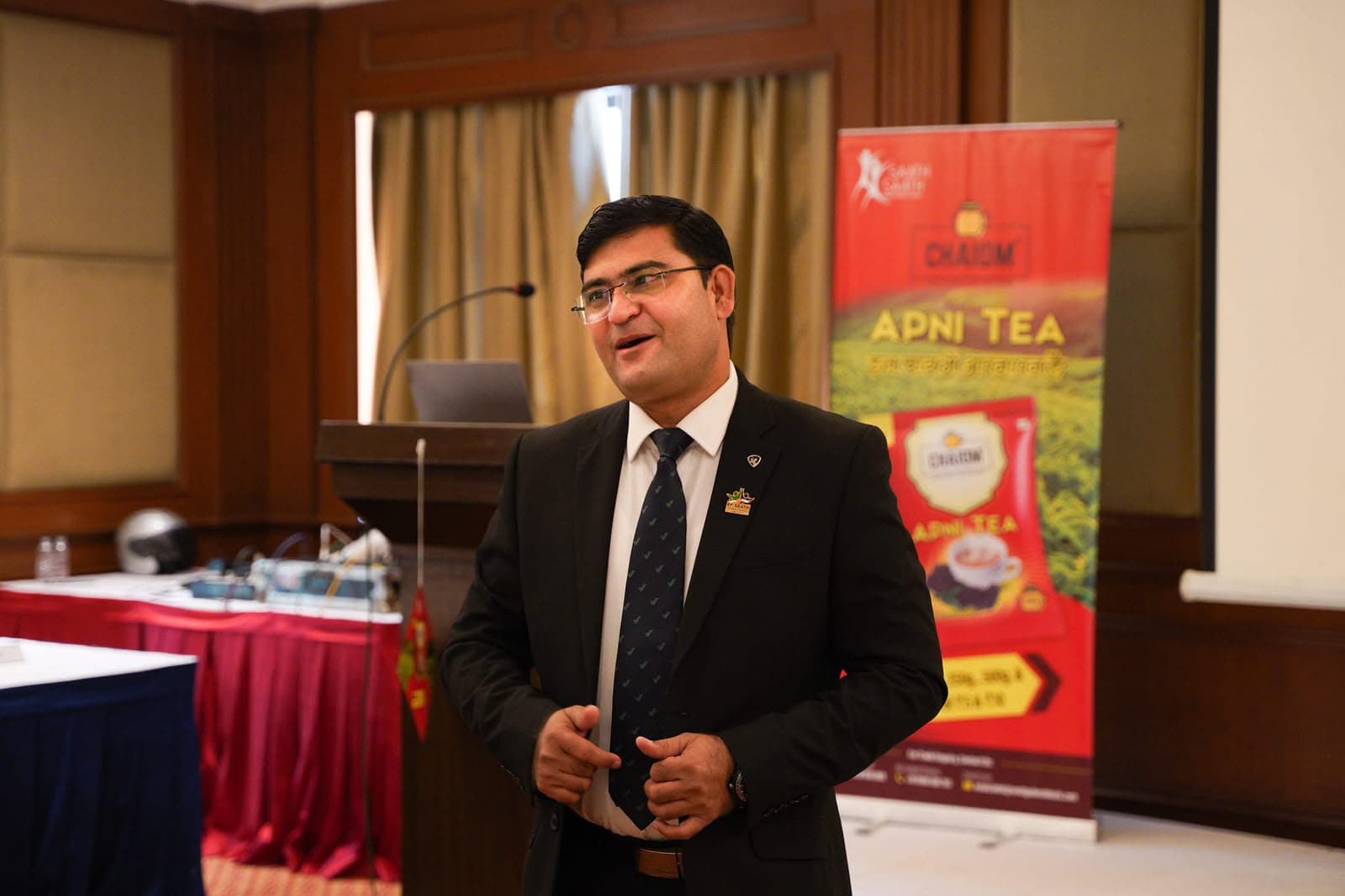 Aadesh Sharma smiling while presenting at a business event